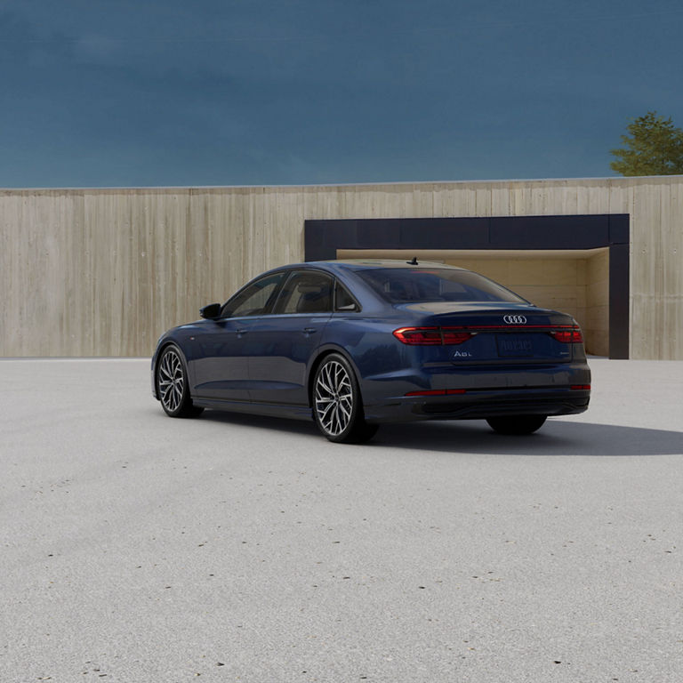 Three-quarter rear view of an Audi A8 parked.