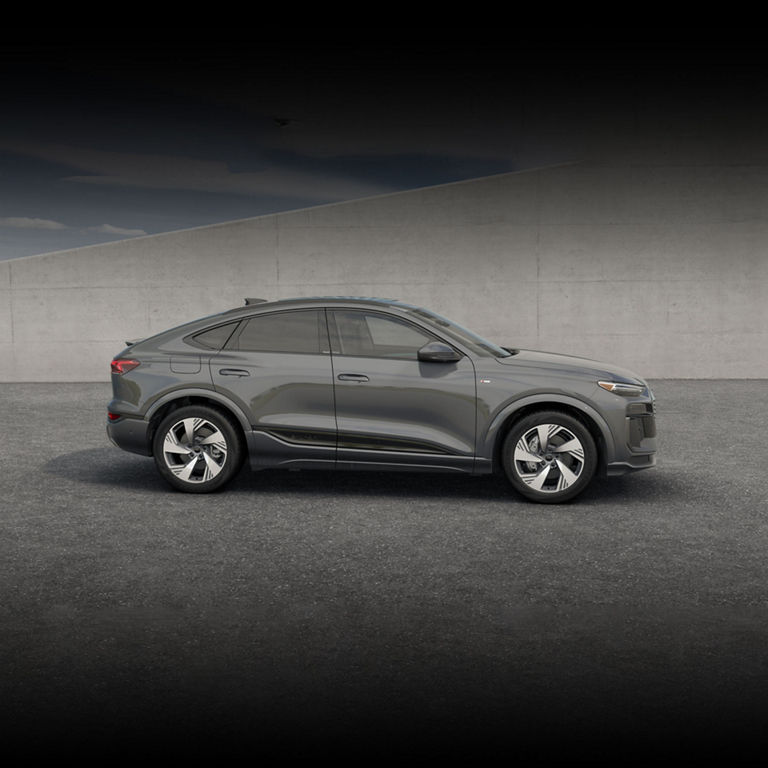 Side view of a black Audi Q6 Sportback e-tron parked.
