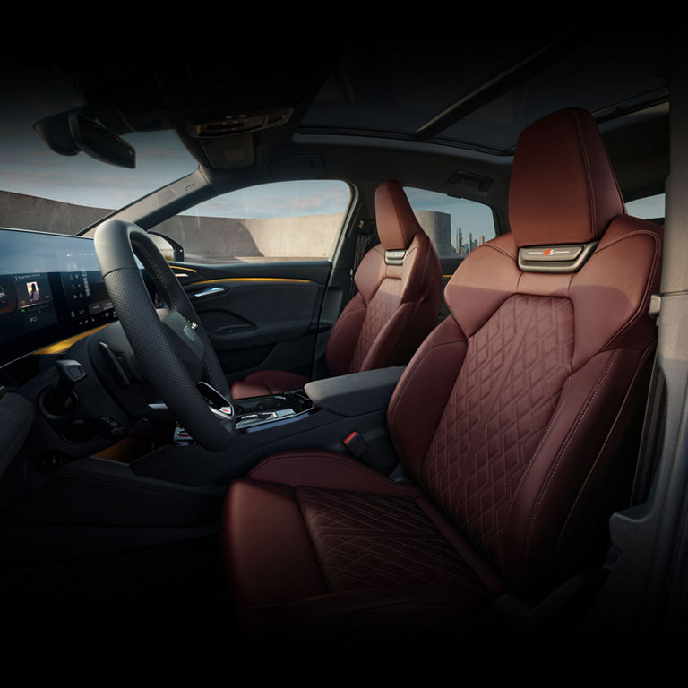 Interior view of the Audi SQ6 Sportback e-tron, showing the front sport seats in red leather.