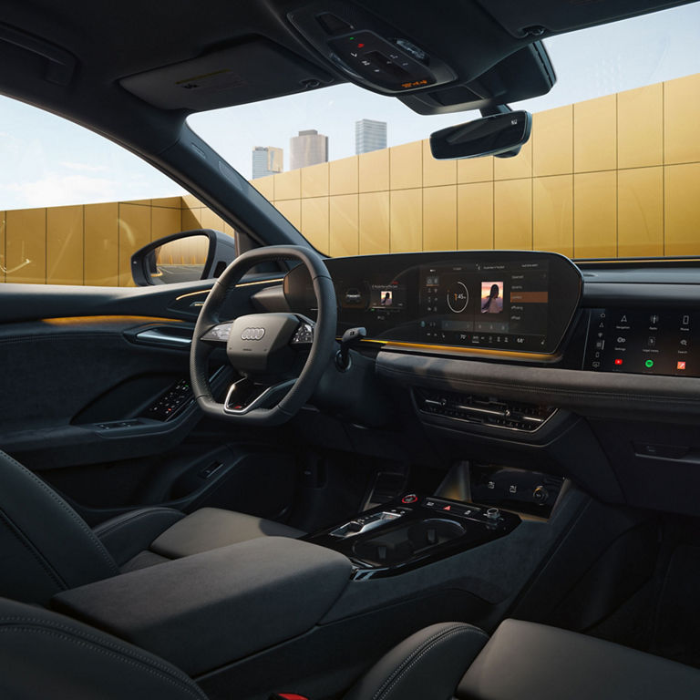 Close-up on the Audi virtual cockpit and steering wheel in the Audi SQ6 Sportback e-tron, depicting the interaction light strip feature.