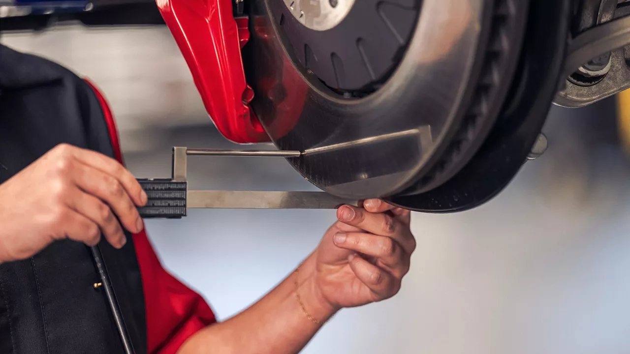 An Audi mechanic working on a vehicle. 