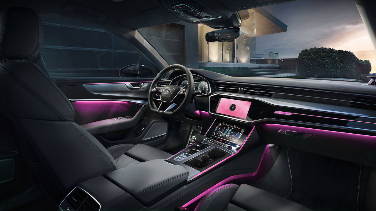 Interior view of Audi vehicle displaying MMI, Virtual Cockpit and wheel.