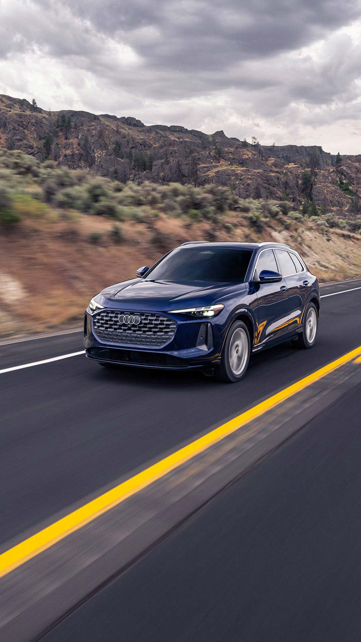 Three-quarter side profile of an Audi A5 accelerating.