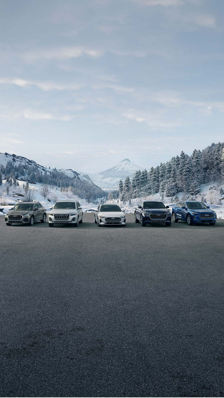 Three-quarter side profile of an Audi A6 accelerating.