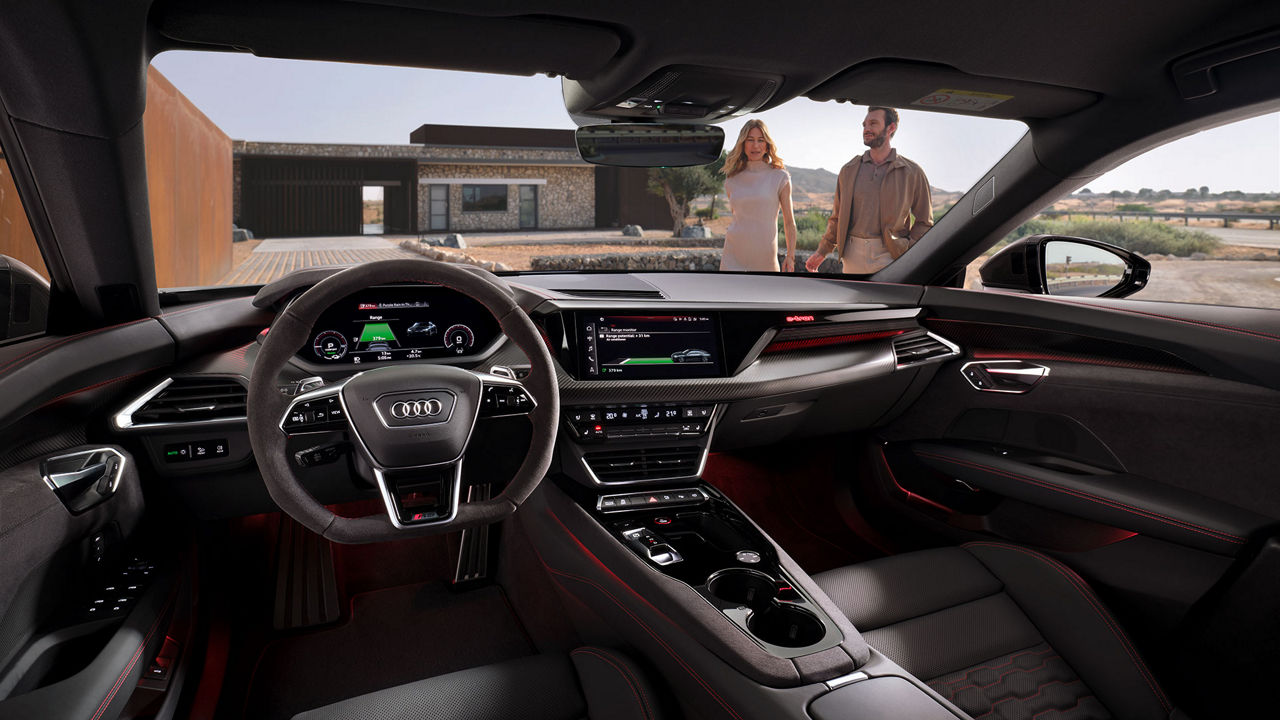 Interior view of the Audi RS e-tron GT showing the wheel and MMI screen. 