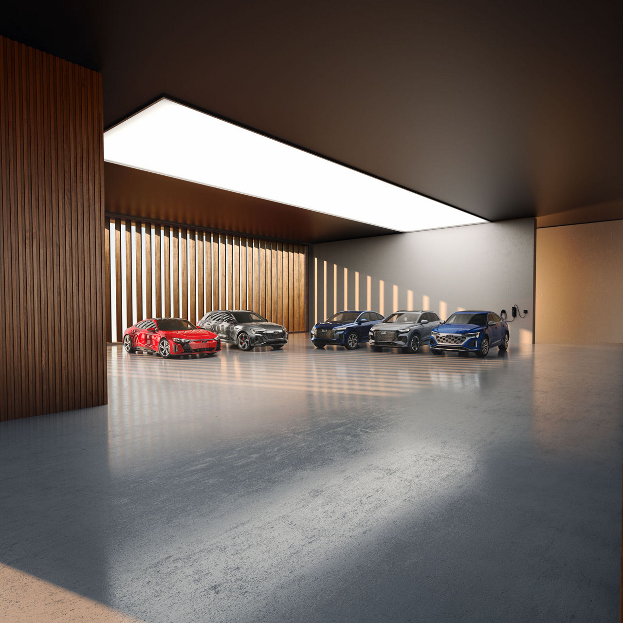 Five Audi vehicles parked inside a wood-paneled vehicle showroom.