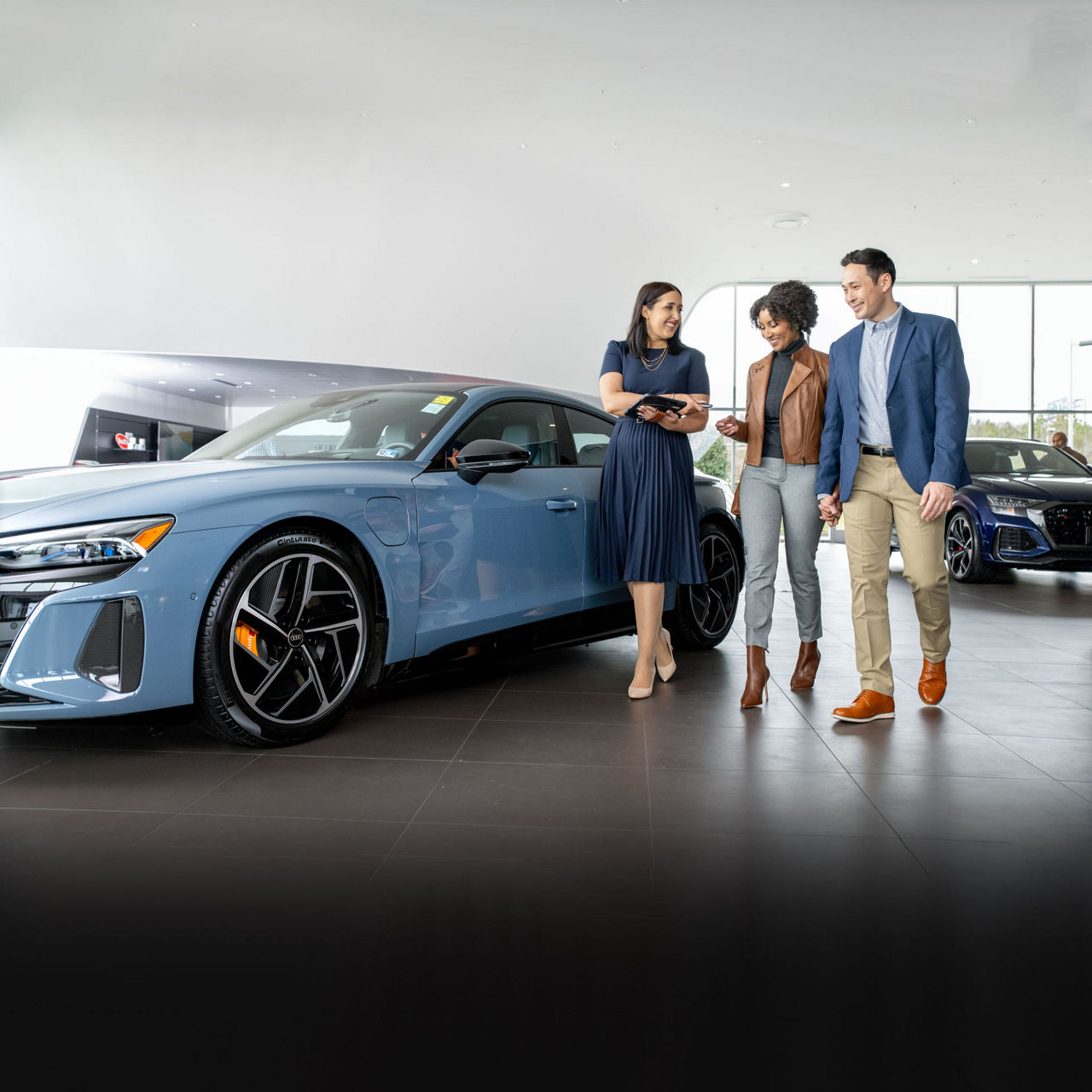 An Audi dealer showing a customer how to charge his Audi e-tron vehicle.