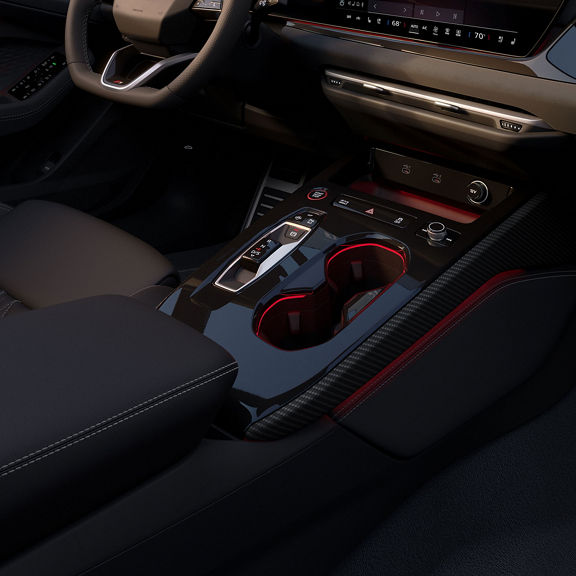 Interior view of the Audi S5, showing the gearbox, dashboard, and steering wheel.