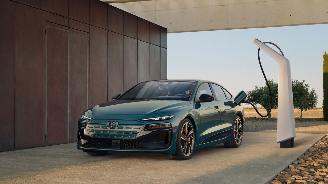 Three-quarter front profile of an Audi Q8 Sportback e-tron parked and charging on a driveway.