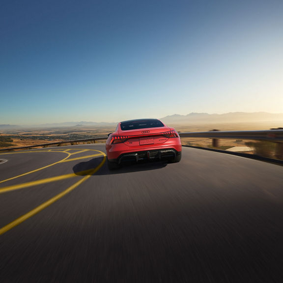 Rear view of the Audi RS e-tron GT in motion.