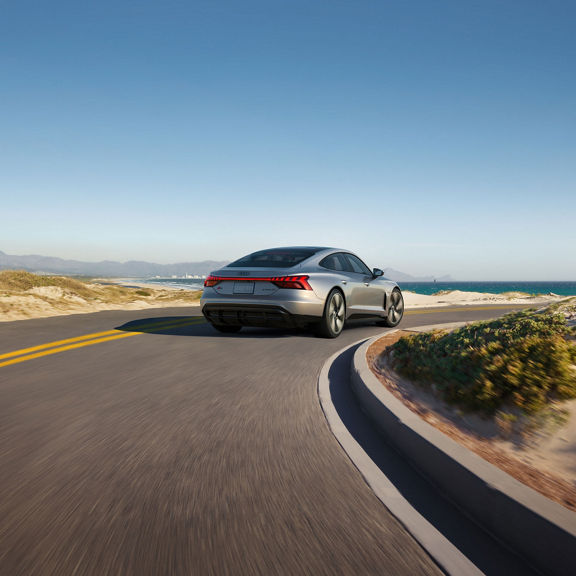 Three-quarter rear view of the Audi S e-tron GT in motion.
