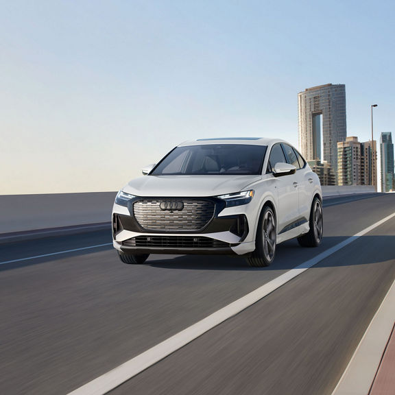 Front profile of the Audi Q4 Sportback e-tron accelerating. 