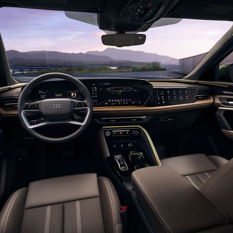 View of the interior cabin, showing the dash and front seats, of the Audi Q5 Sportback.