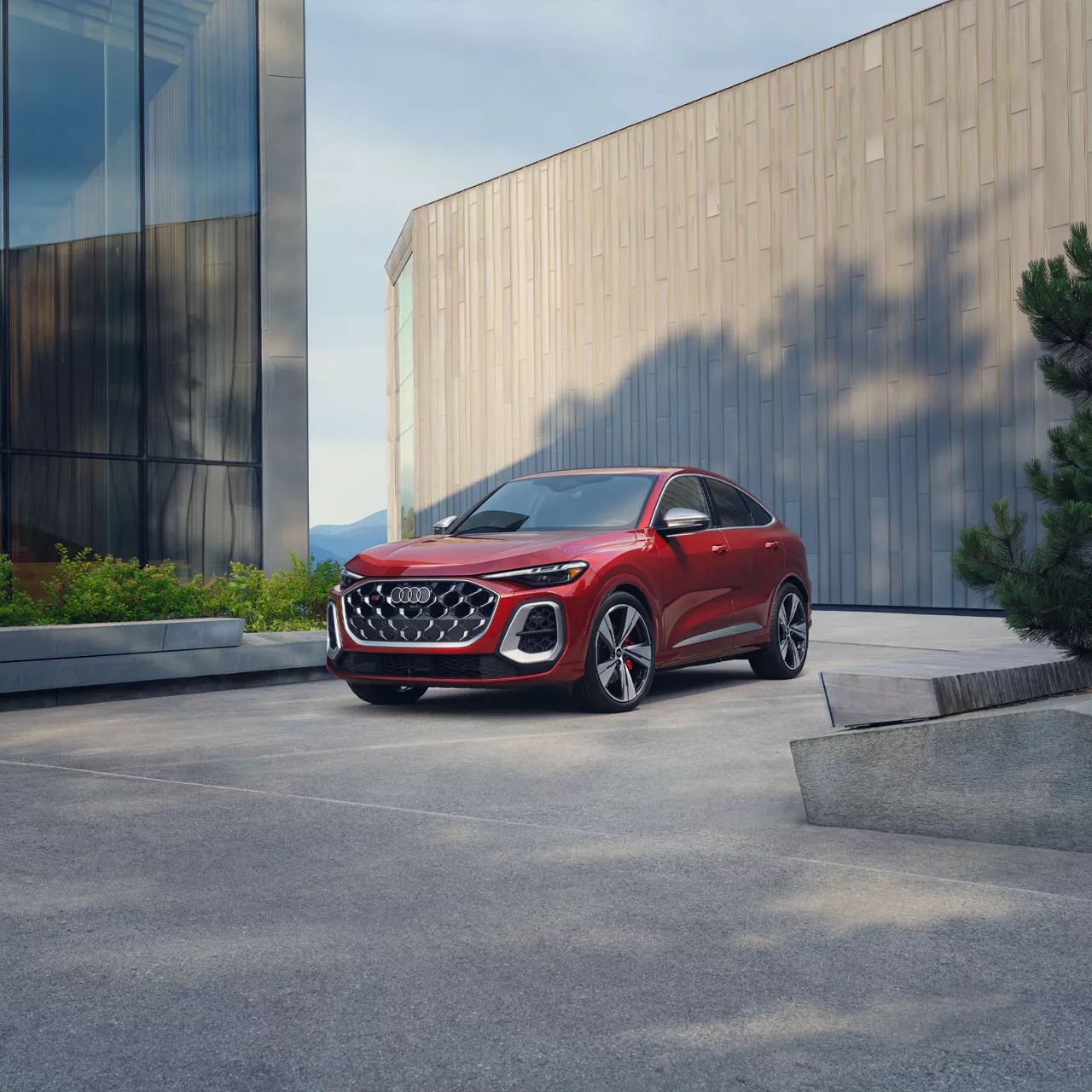 An Audi technician servicing a vehicle.