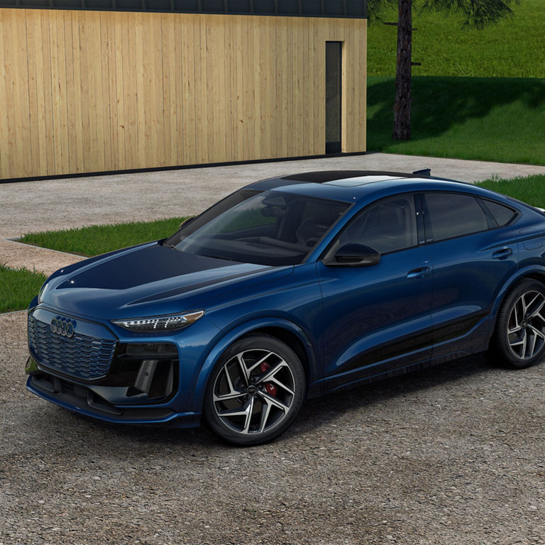 Three-quarter side view of the Audi SQ6 Sportback e-tron parked on a driveway. 