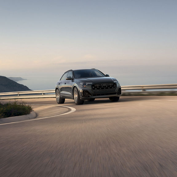 Three-quarter front view of the Audi SQ8 accelerating.