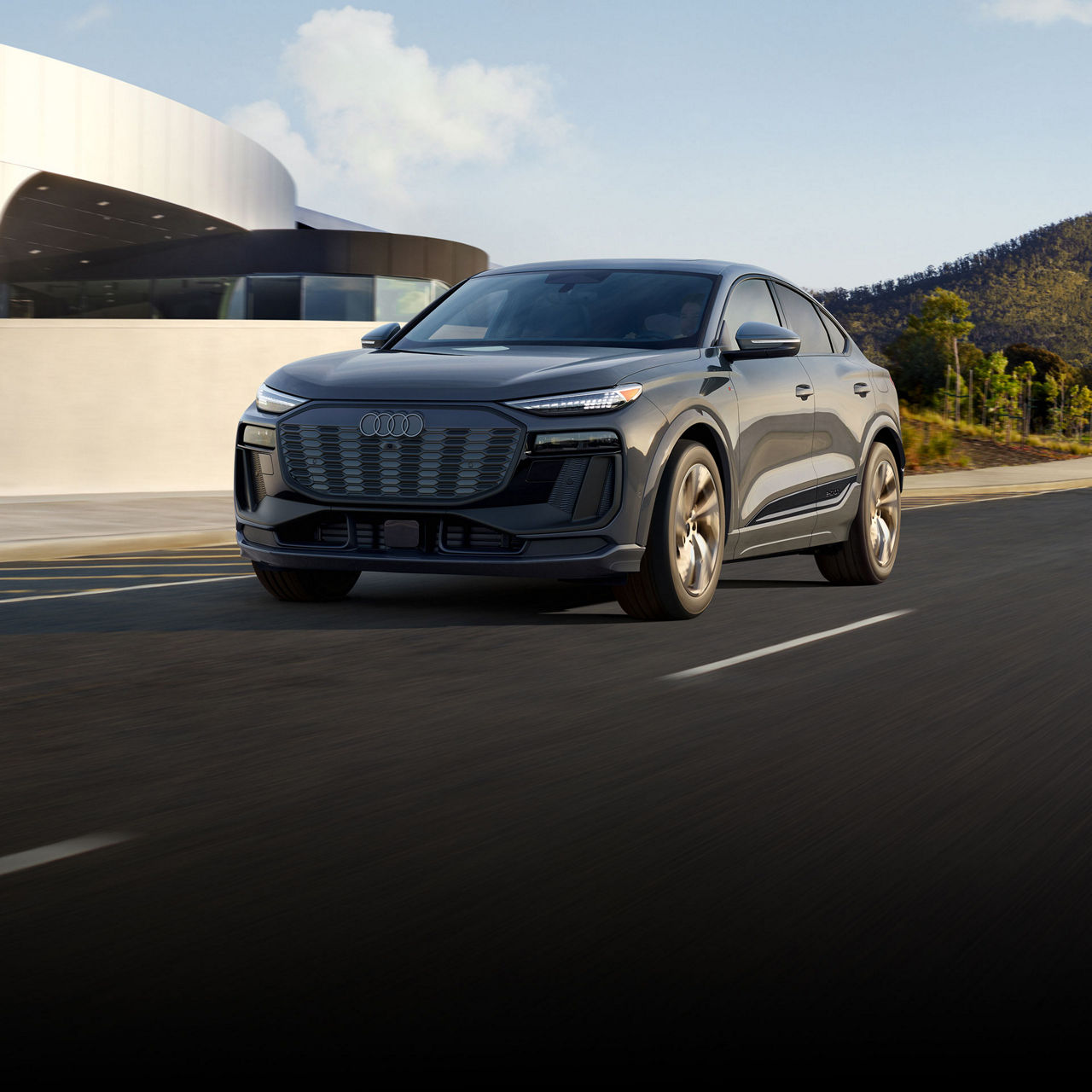Three-quarter front view of the Audi Q6 Sportback e-tron in motion.