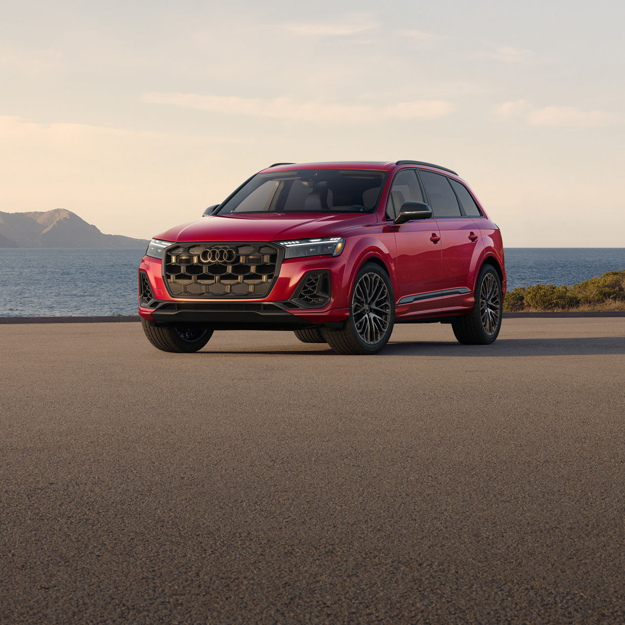 Three-quarter front profile of the Audi SQ7 parked by a waterfront.