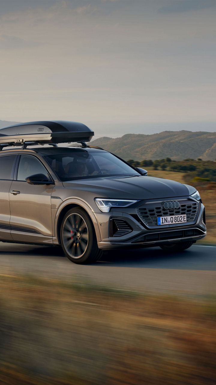 Audi Vehicle driving on a country road.