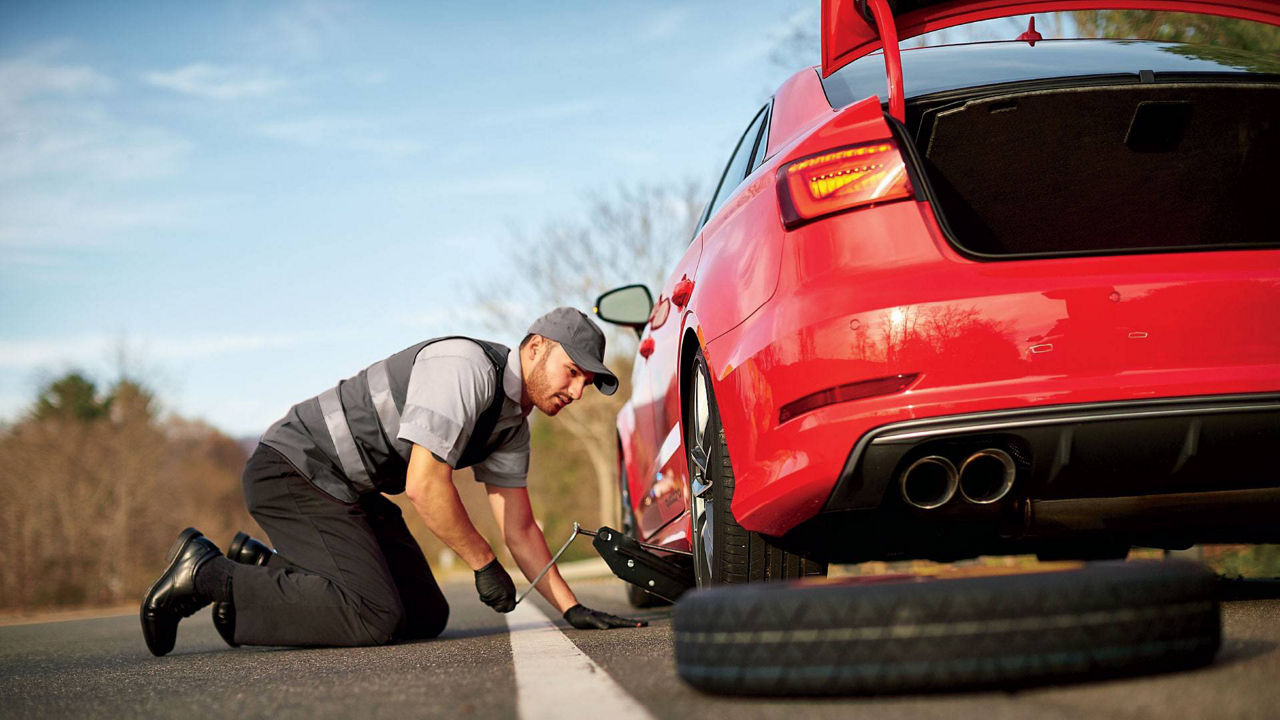 An Audi technican servicing a vehicle.