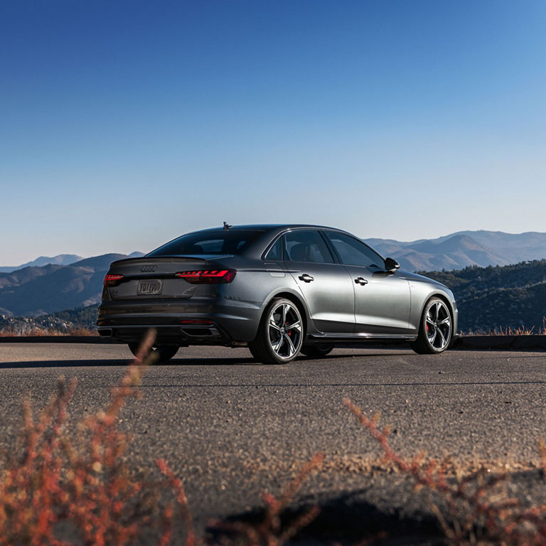 Three-quarter rear view of the Audi A4 Sedan parked.