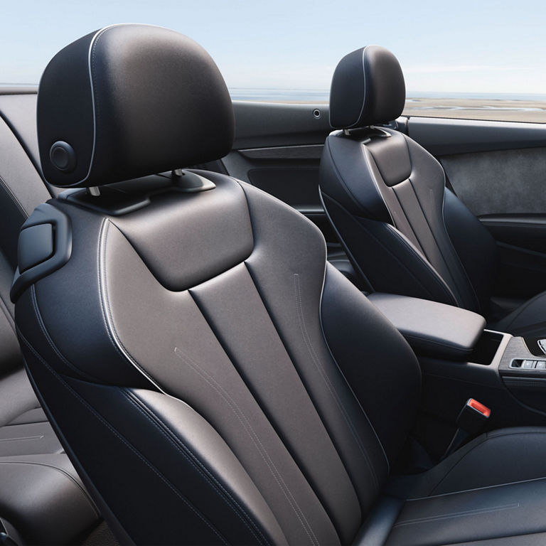 Close-up of the front sport seats and centre console in the Audi A5 Cabriolet.