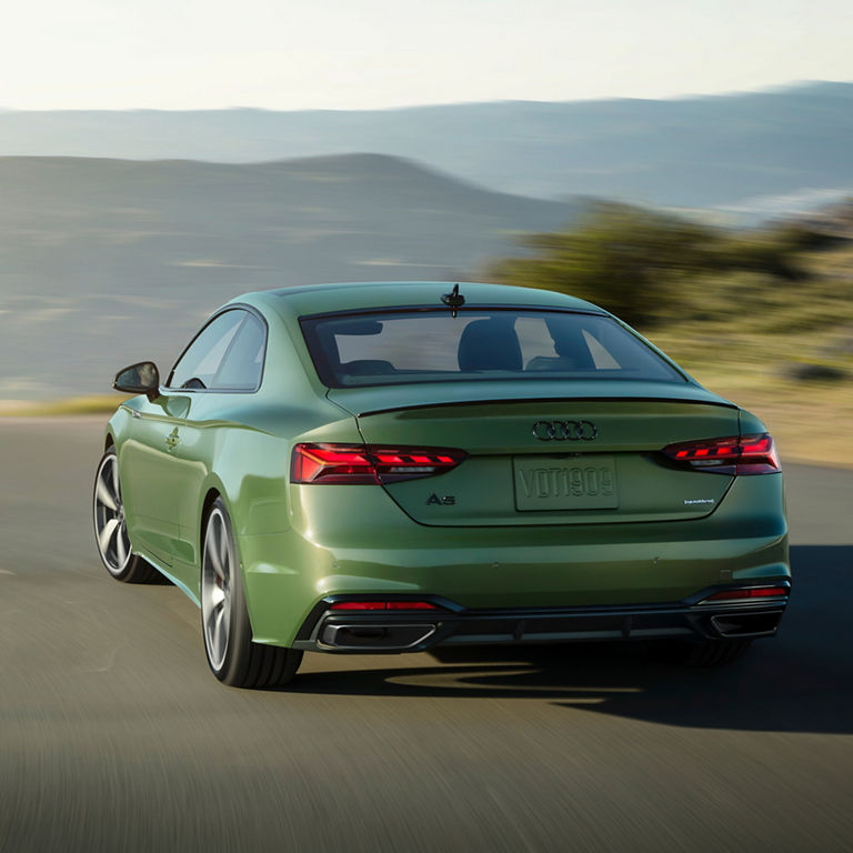 Three-quarter back view of the Audi A5 Coupe in motion. 