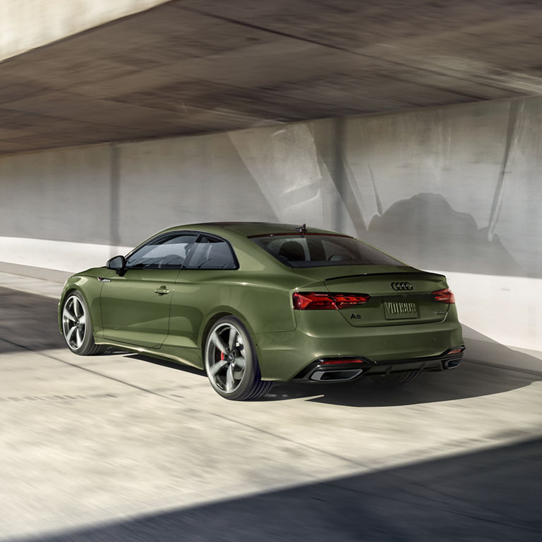 Three-quarter rear profile of the Audi A5 Coupe. 