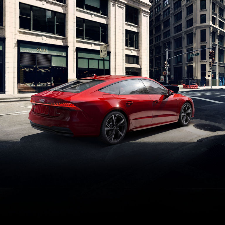 Three-quarter rear view of the Audi A7 parked. 