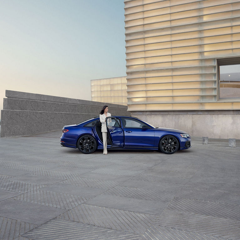 Side view of a woman exiting the Audi S8.