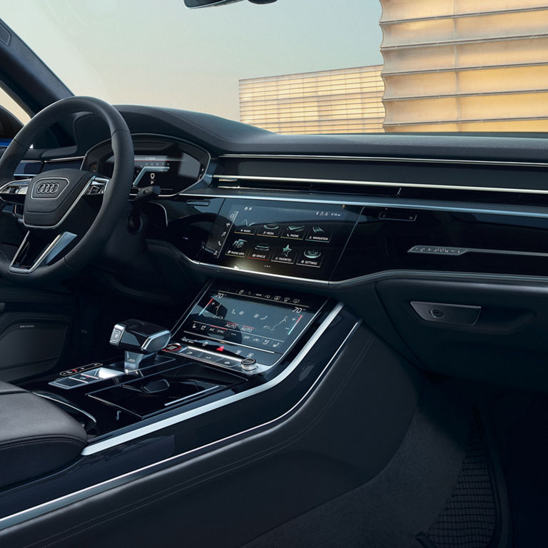 Interior shot of the front seat, Audi MMI and steering wheel.