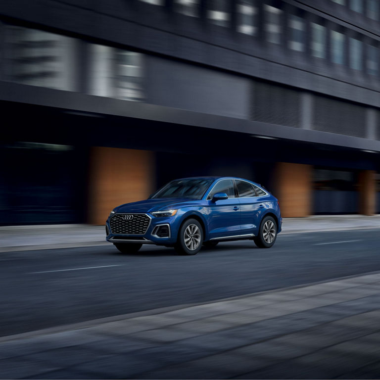 Three-quarter side view of the Audi Q5 Sportback accelerating.