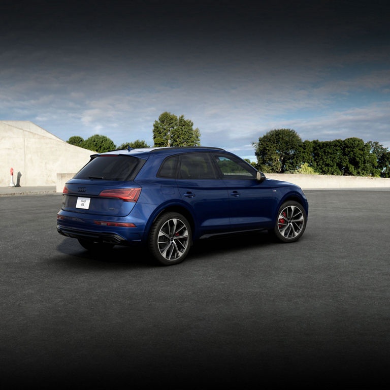 Three-quarter side view of a blue Audi Q5. 