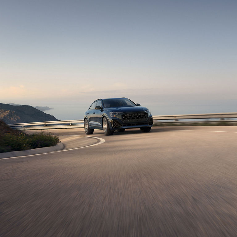 Three-quarter front view of the Audi SQ8 accelerating.