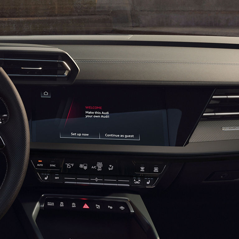 Close-up of a smartphone on the wireless charging pad in the Audi S3.