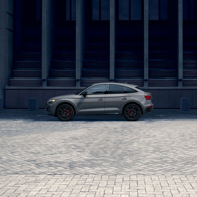 Side profile of a grey Audi SQ5 Sportback parked.