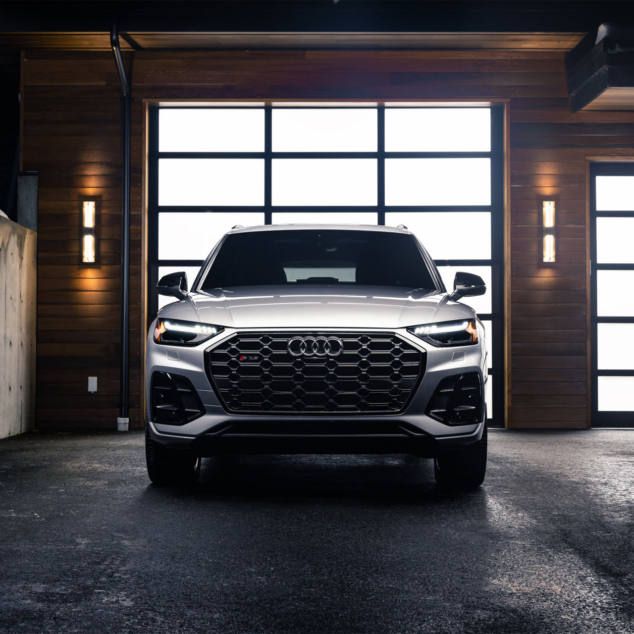 Front profile view of an Audi SQ5 accelerating.