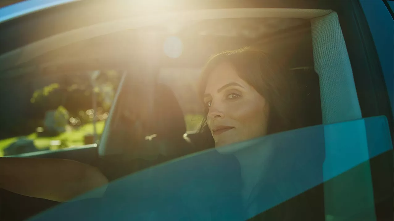 A woman in an Audi with the window down.