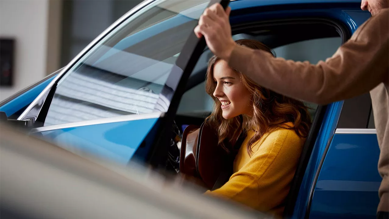 A woman exiting an Audi.