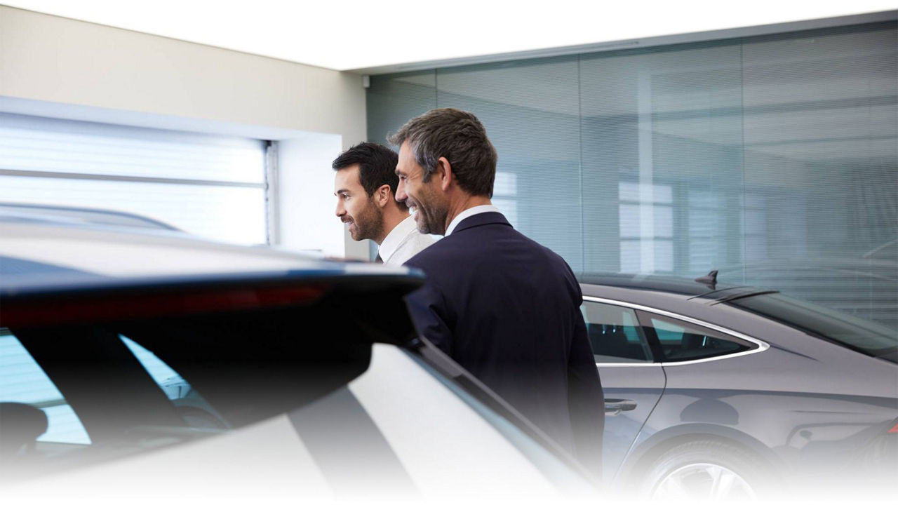 Two people in an Audi showroom.