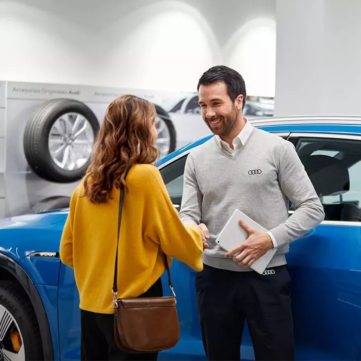 Propriétaire d’une Audi ayant une conversation avec un employé.