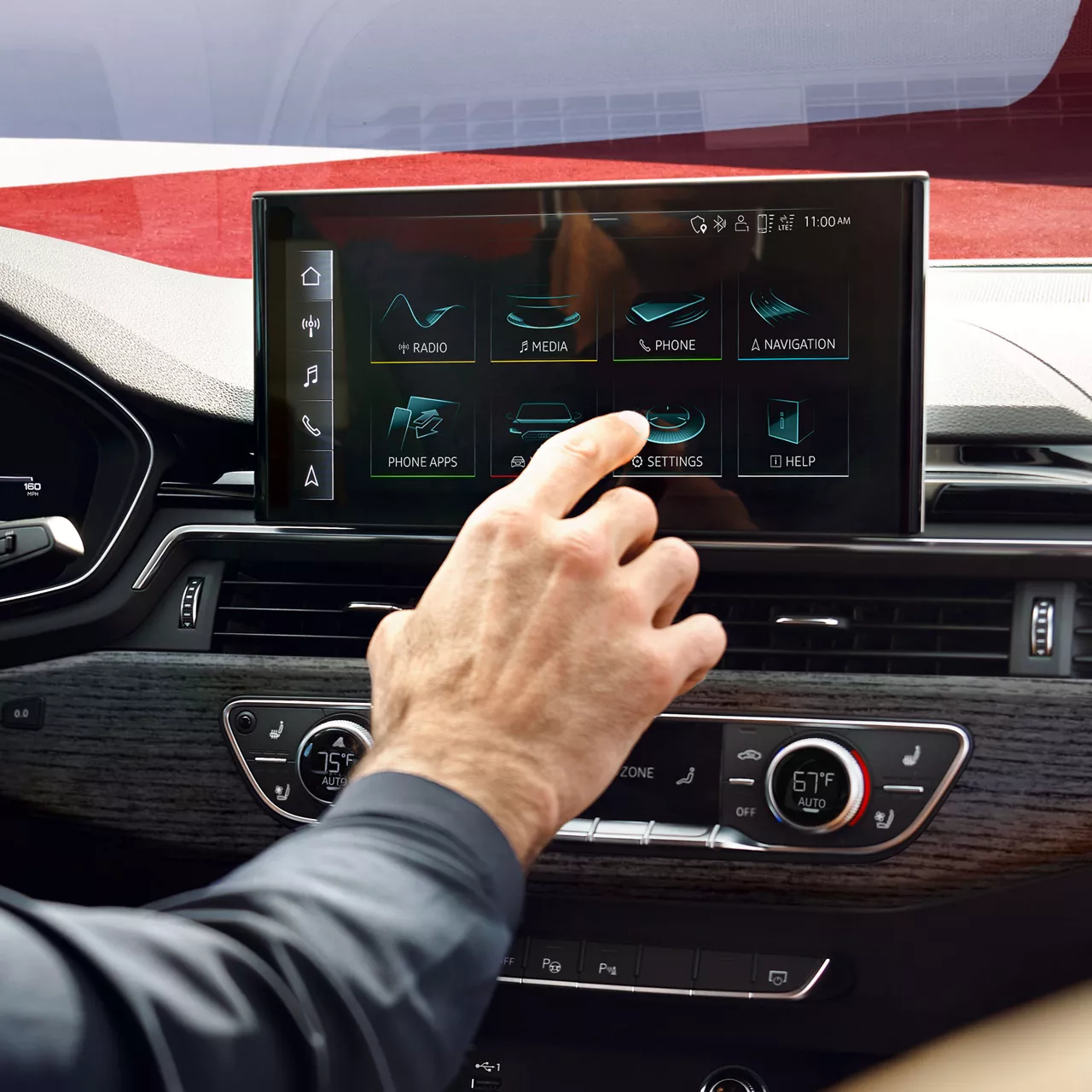 Close-up of a person navigating the MMI touch display in their Audi.