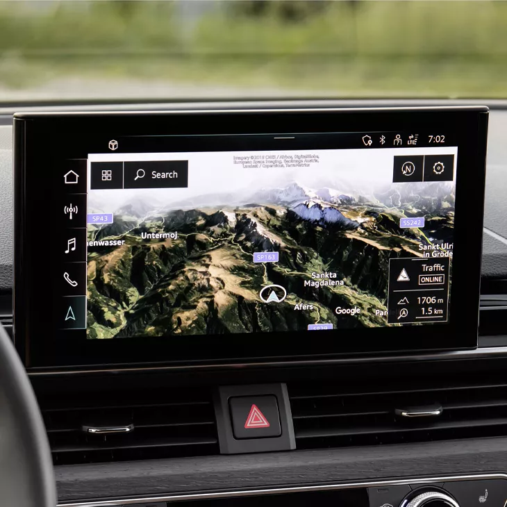 Close up on the Audi MMI screen displaying a satellite map of mountains.