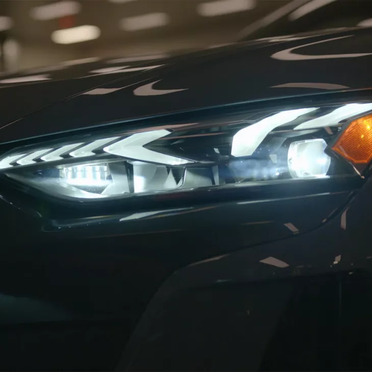 Close up on the headlights of an Audi vehicle.