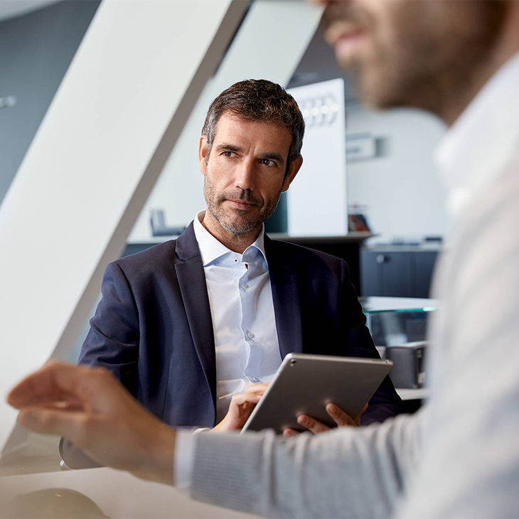 Audi employee helping a customer access his finance account.