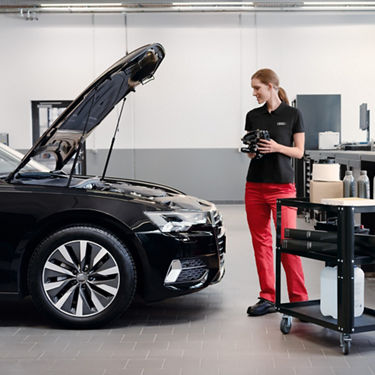 An Audi Technician servicing an Audi vehicle.