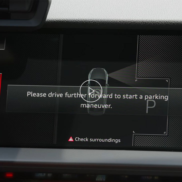 Close-up of the Audi MMI system displaying park assist technology. 