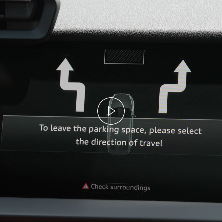 Close-up of the Audi MMI system displaying park assist technology. 