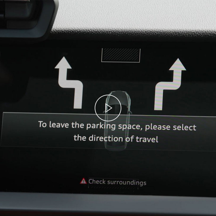 Close-up of the Audi MMI system displaying park assist technology. 