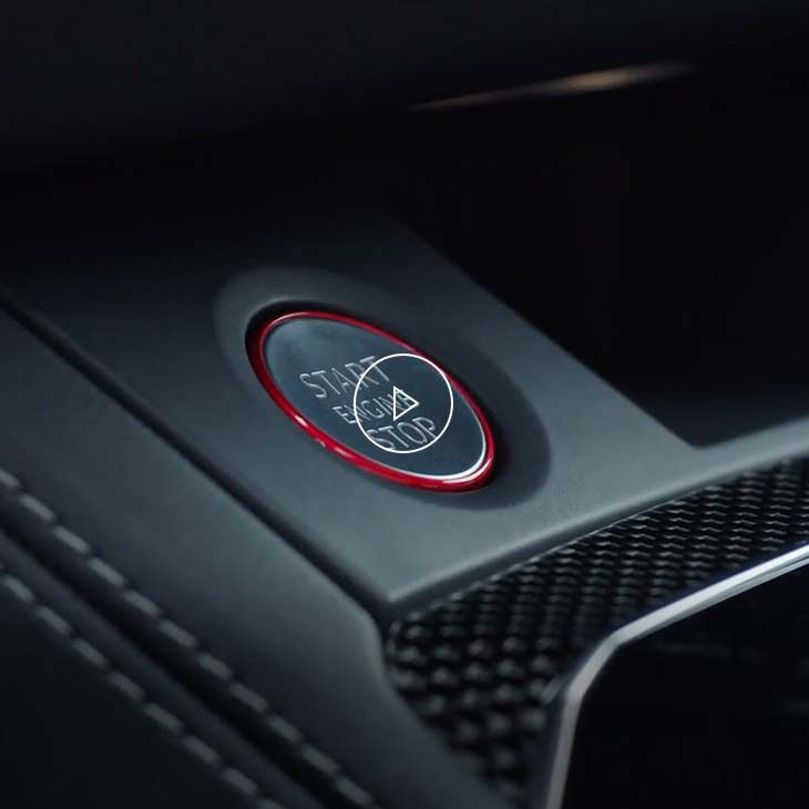 Close-up photo of the Stop-start engine button inside an Audi vehicle. 